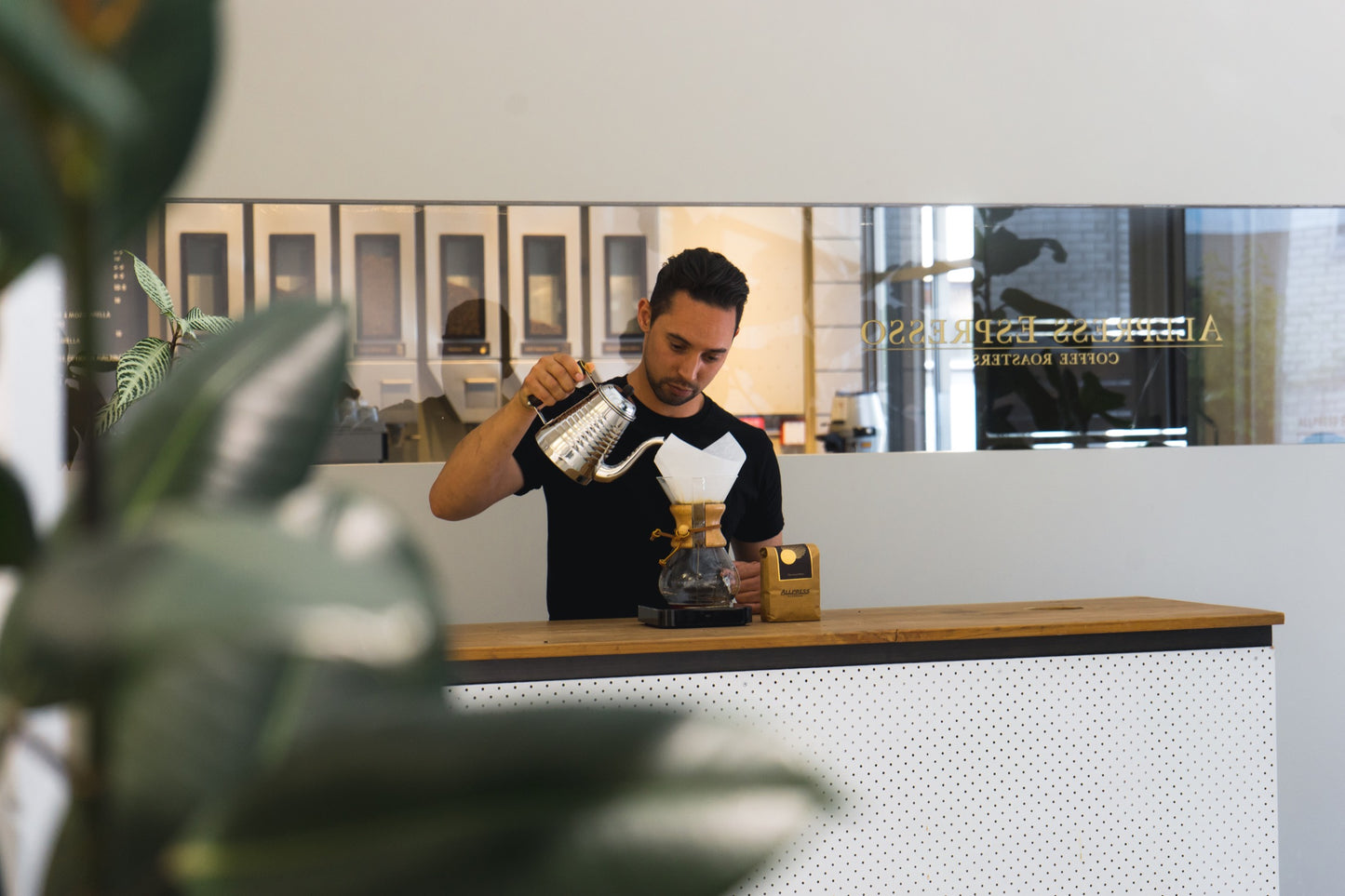 Charlie pours hot water into a Chemex pour-over.